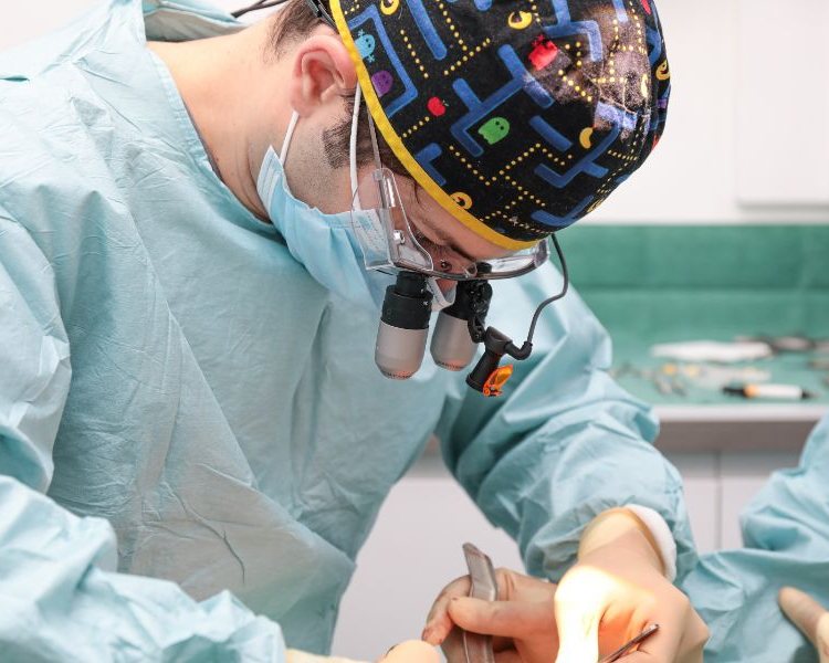 Dr Eric Battista operating with surgical loupes at EB Dental