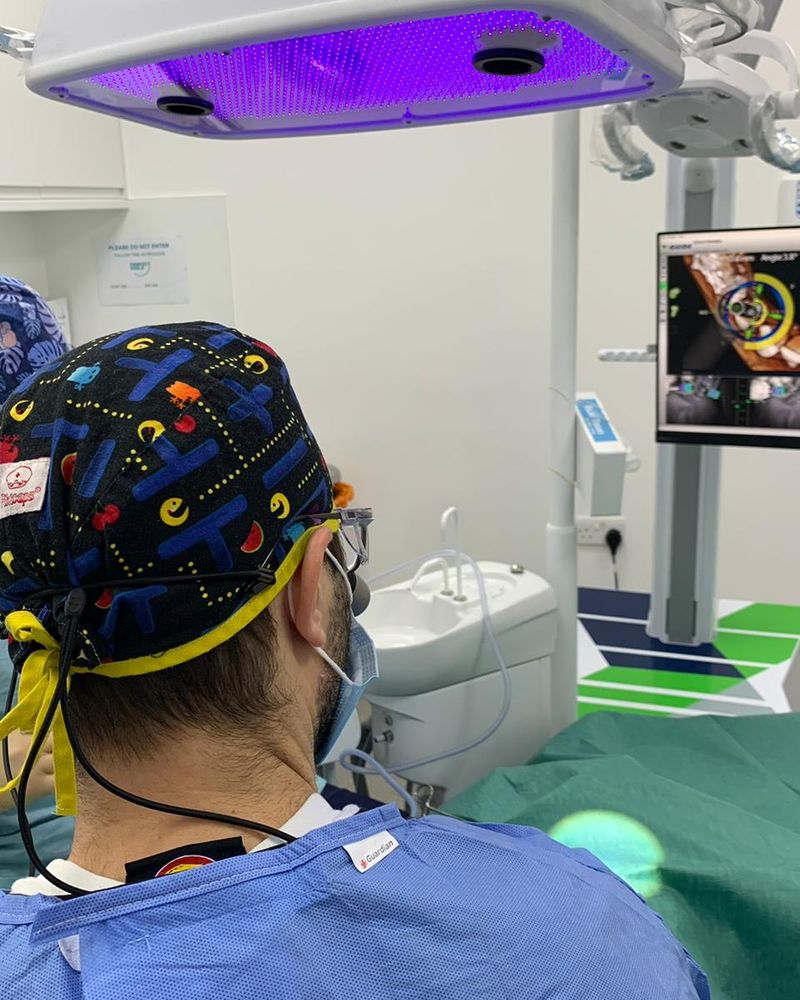 Dr Eric Battista and the surgical team reviewing the navigation screen