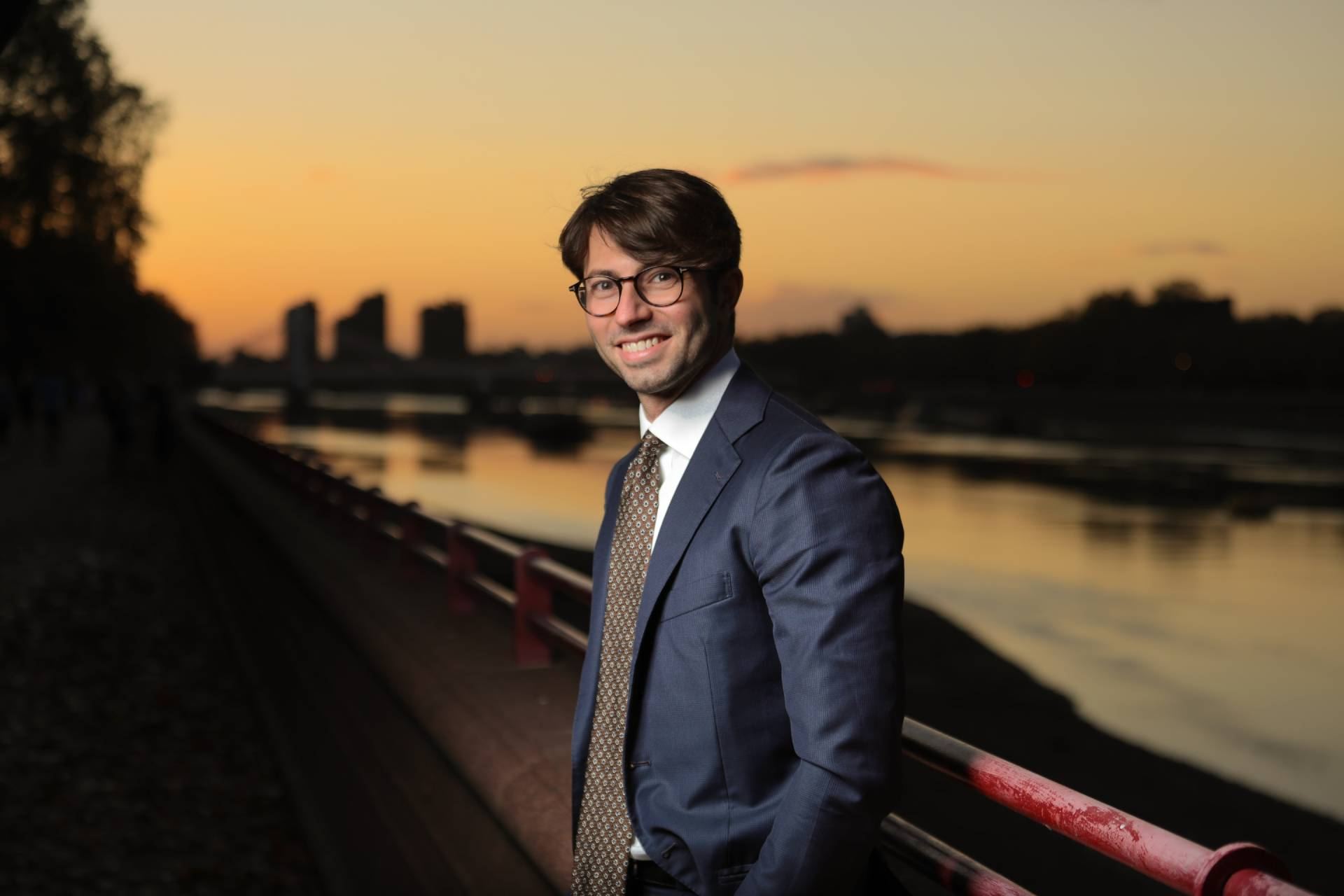 Dr Eric Battista by the River Thames in London at sunset