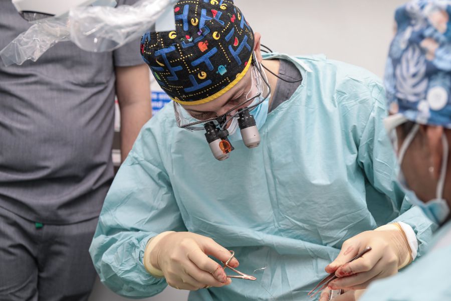 Dr Eric Battista performing oral surgery with his team