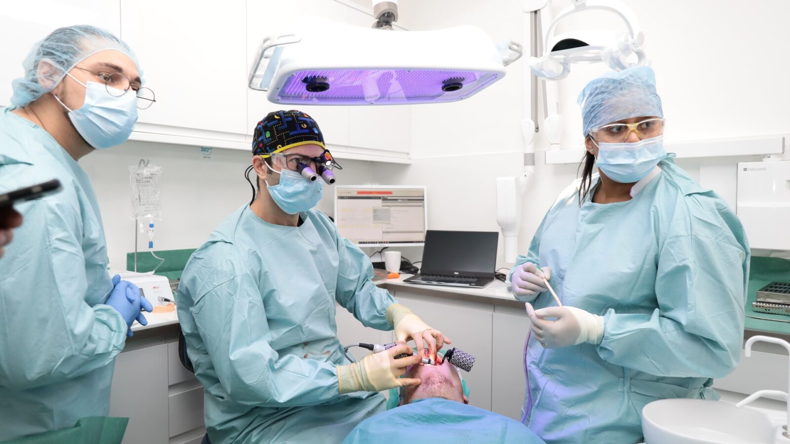 Surgical team reviewing a CBCT scan on screen